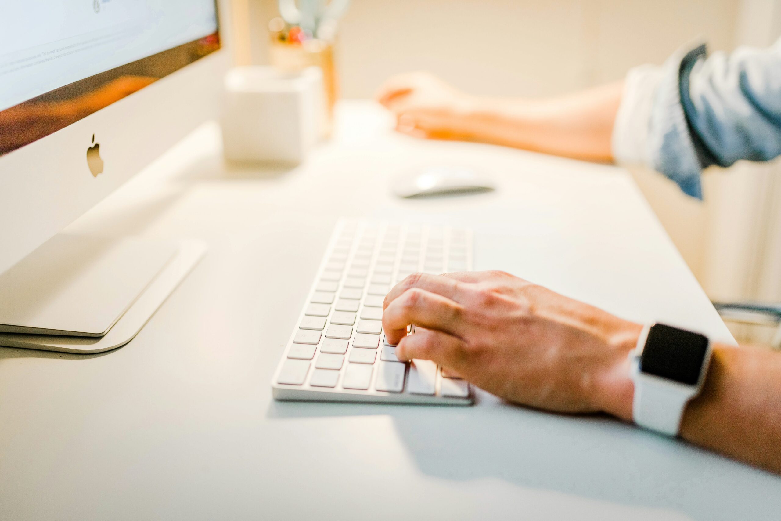 man typing on keyboard. Photo by Austin Distel on Unsplash